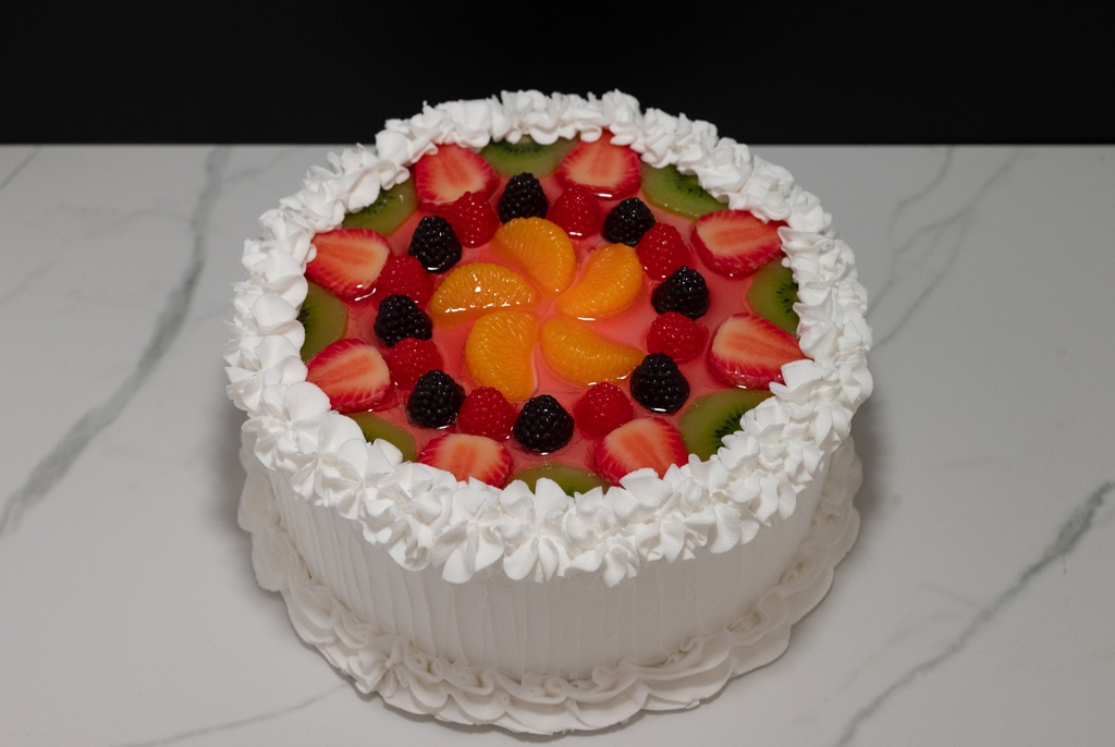 Large Vanilla Frosted Cake Topped with Fruit