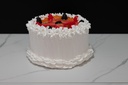 Small Vanilla Frosted Cake Topped with Fruit